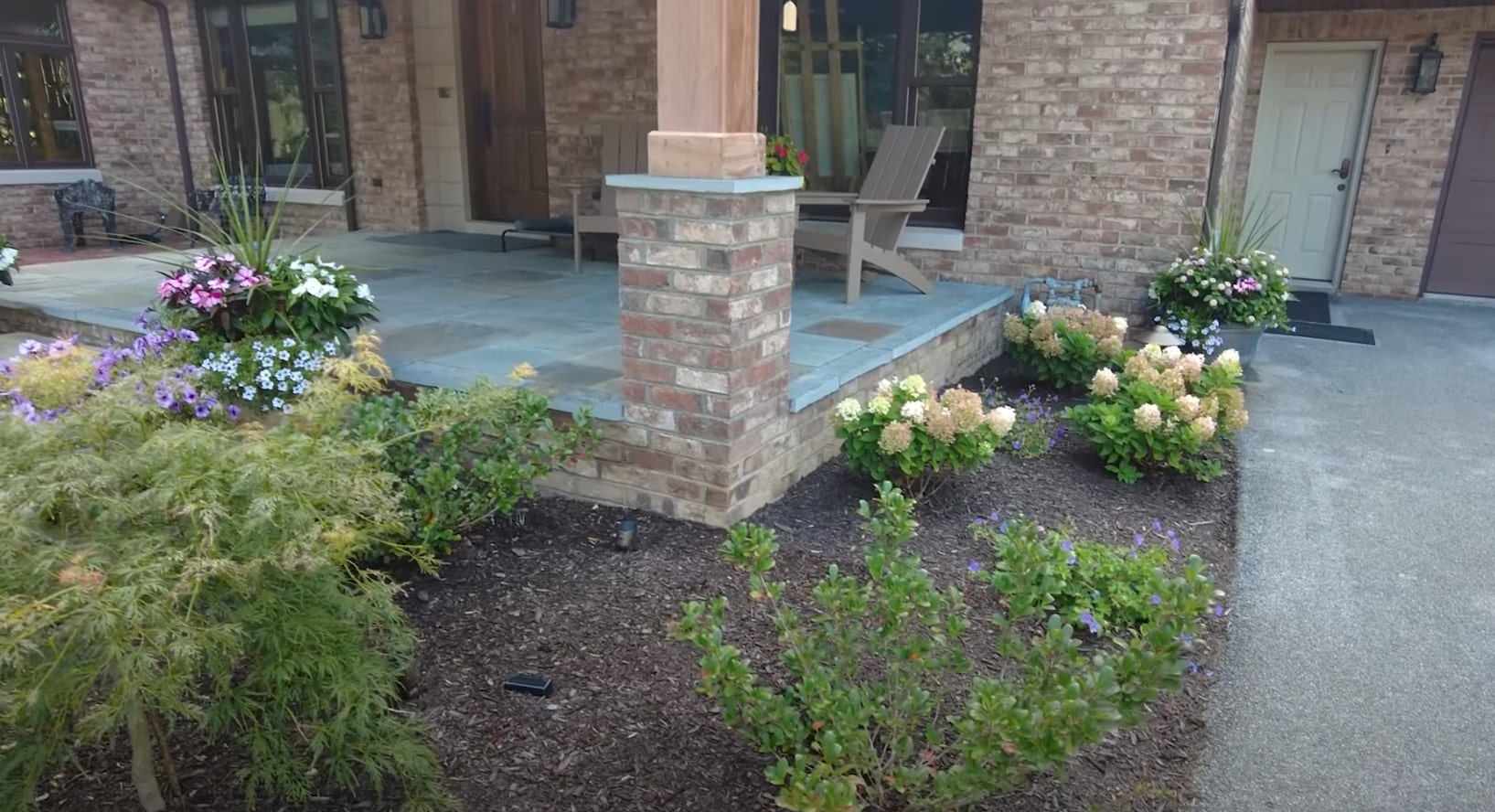 Custom patio design with integrated landscaping and outdoor living space Modern outdoor patio with professional landscaping and hardscaping in Doral